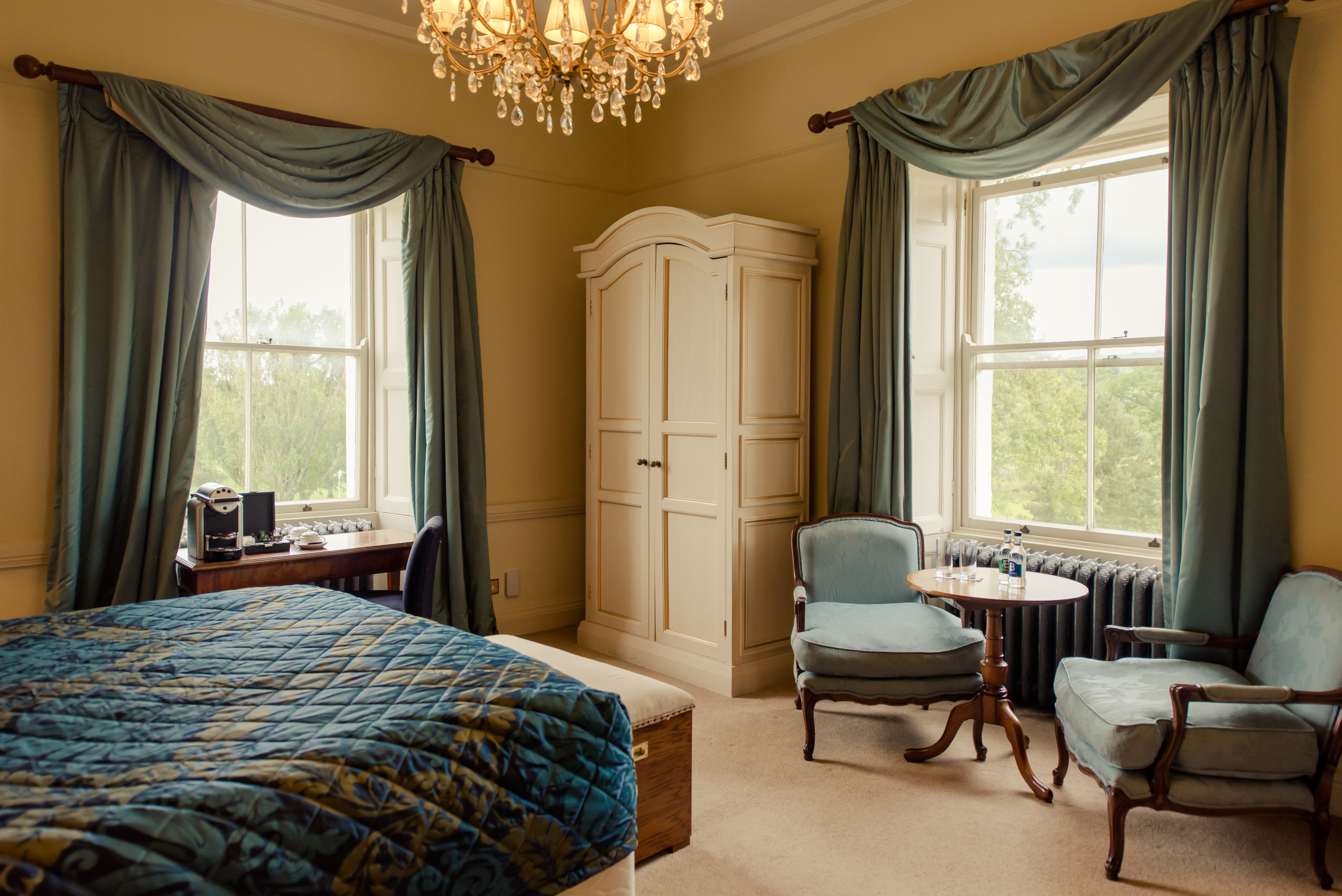 Tulfarris Hotel & Golf Resort Manor House bedroom with view out of two windows.jpg