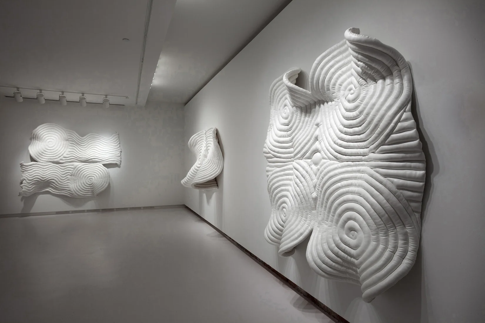 Private Practice (installation view), 2013. Works shown, left to right: Valor , 2013, vinyl, batting, muslin, 81 x 81 x 15 inches Meeting , 2013, vinyl, batting, muslin, 55 x 86 x 17 inches Strength , 2013, vinyl, batting, muslin, 79 x 79 x 15 inches