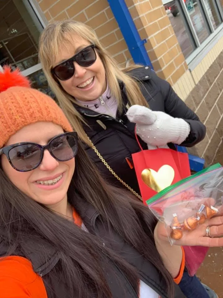 Volunteers handing out Kisses at Blue Goose Market for Random Acts Matter