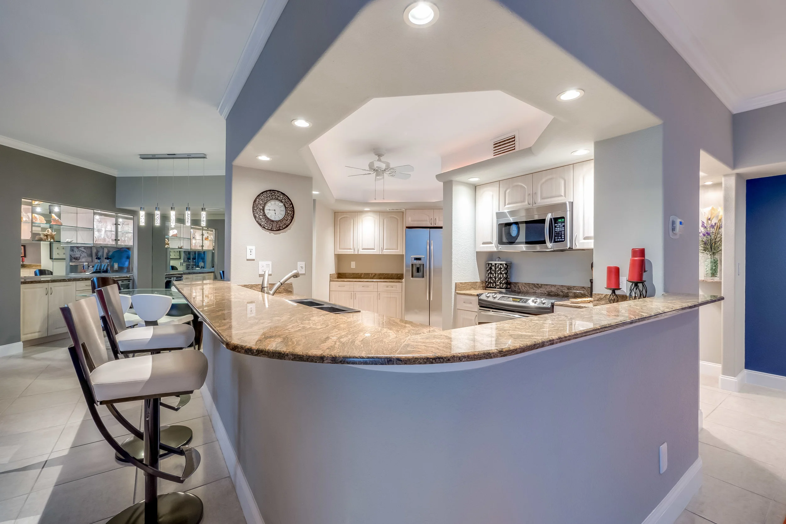 Gorgeous granite, stainless steel appliances, and bar are features of the beautiful kitchen.