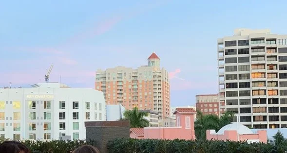 The view from the rooftop bar overlooks the bright buildings of downtown. And you can even wave at the rooftop bar-goers on top of the Art Ovation Hotel right across the way!