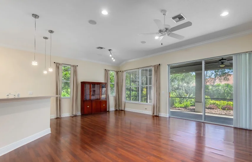 BEFORE: Another undefined “great room” that is difficult to picture actually living in. And you really notice the not-amazing dining room light fixture since there is not much else to draw attention.