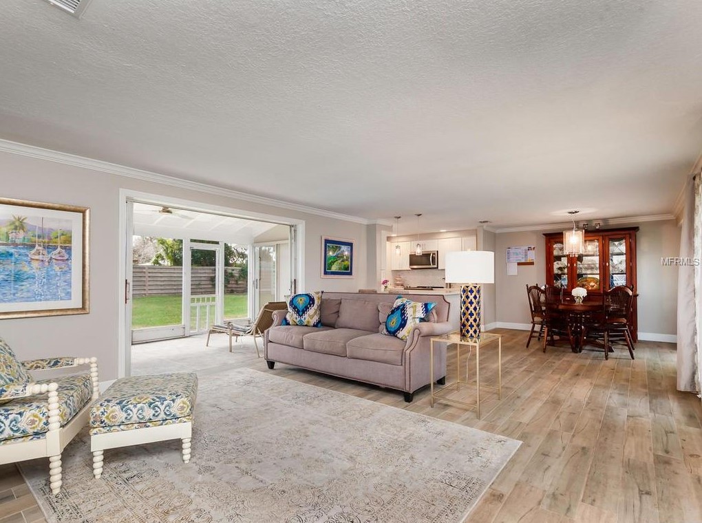 AFTER: Same area, but with a clear living room and dining room that makes the space make sense and adds some fun color.
