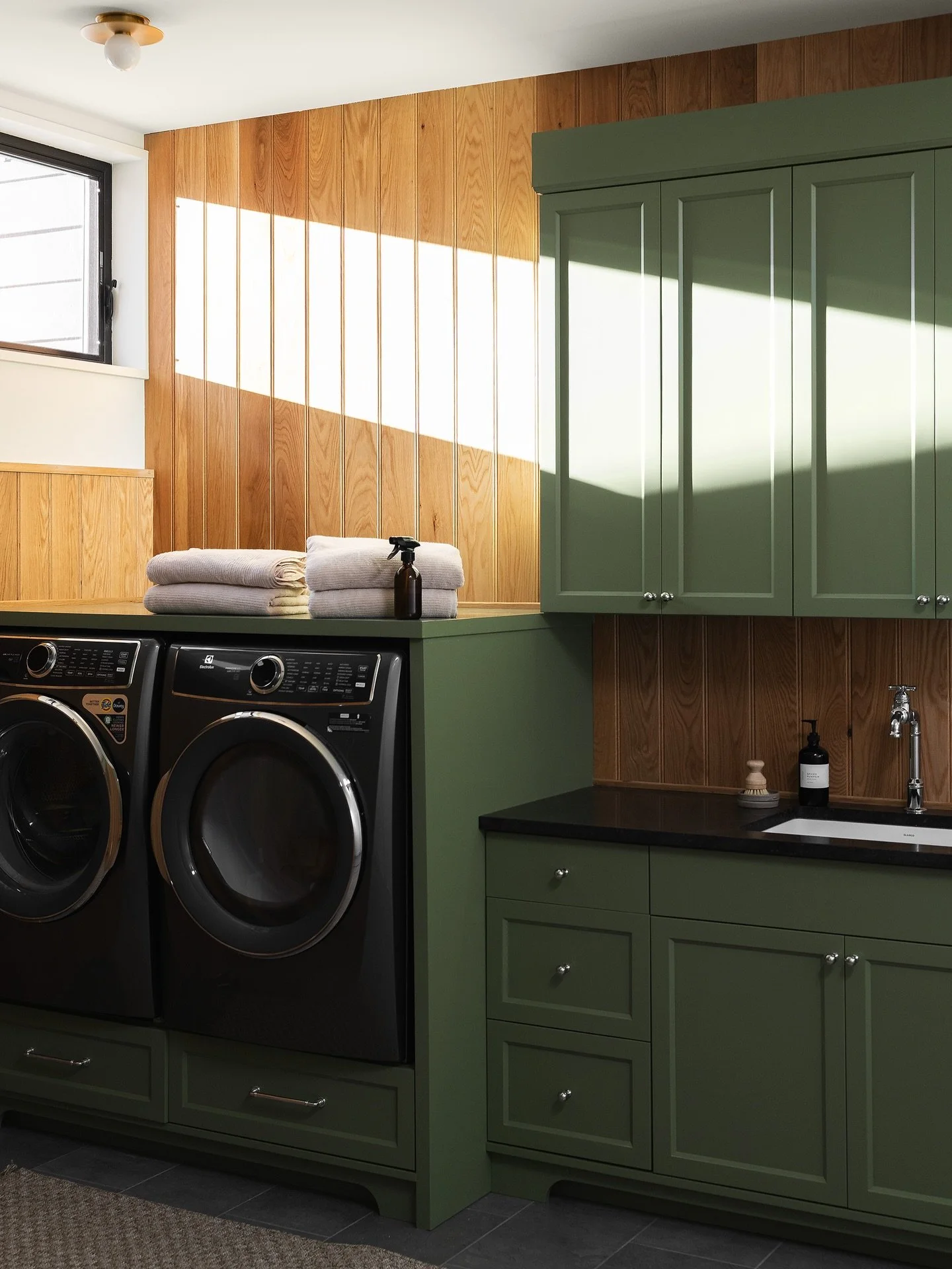 I always ask myself if I would enjoy doing laundry if my own laundry room looked like one of our client projects. The answer is probably not, but a girl can dream. 

Some of my favorite tidbits about this space: 

Evergreen cabinets because laundry r