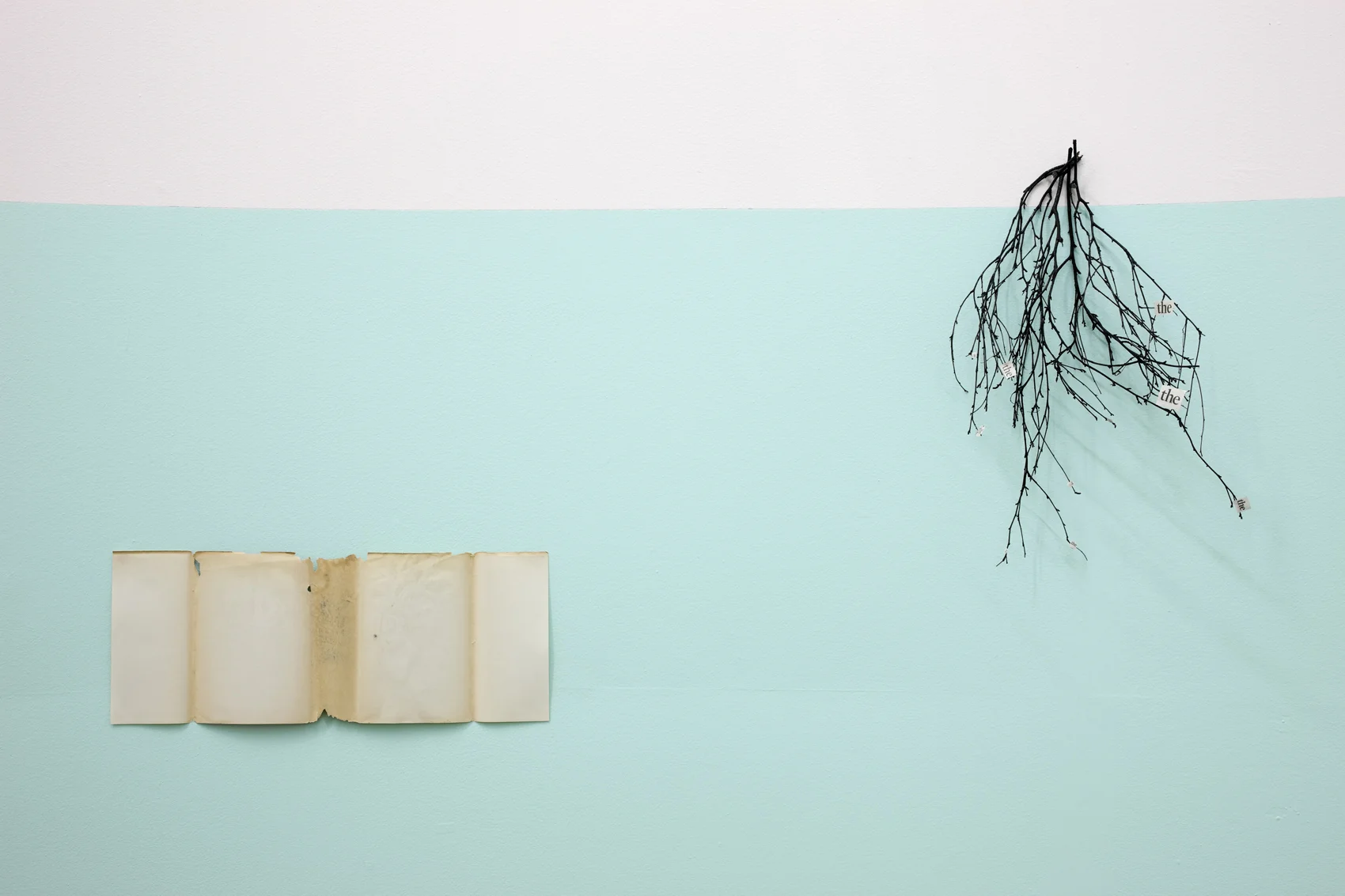 The Golden Bough ( left: Book cover right: T he the) , 2010 . Book jacket, newspaper, white tack and Indian ink on twigs and painted wall . Photo Denis Mortell. 