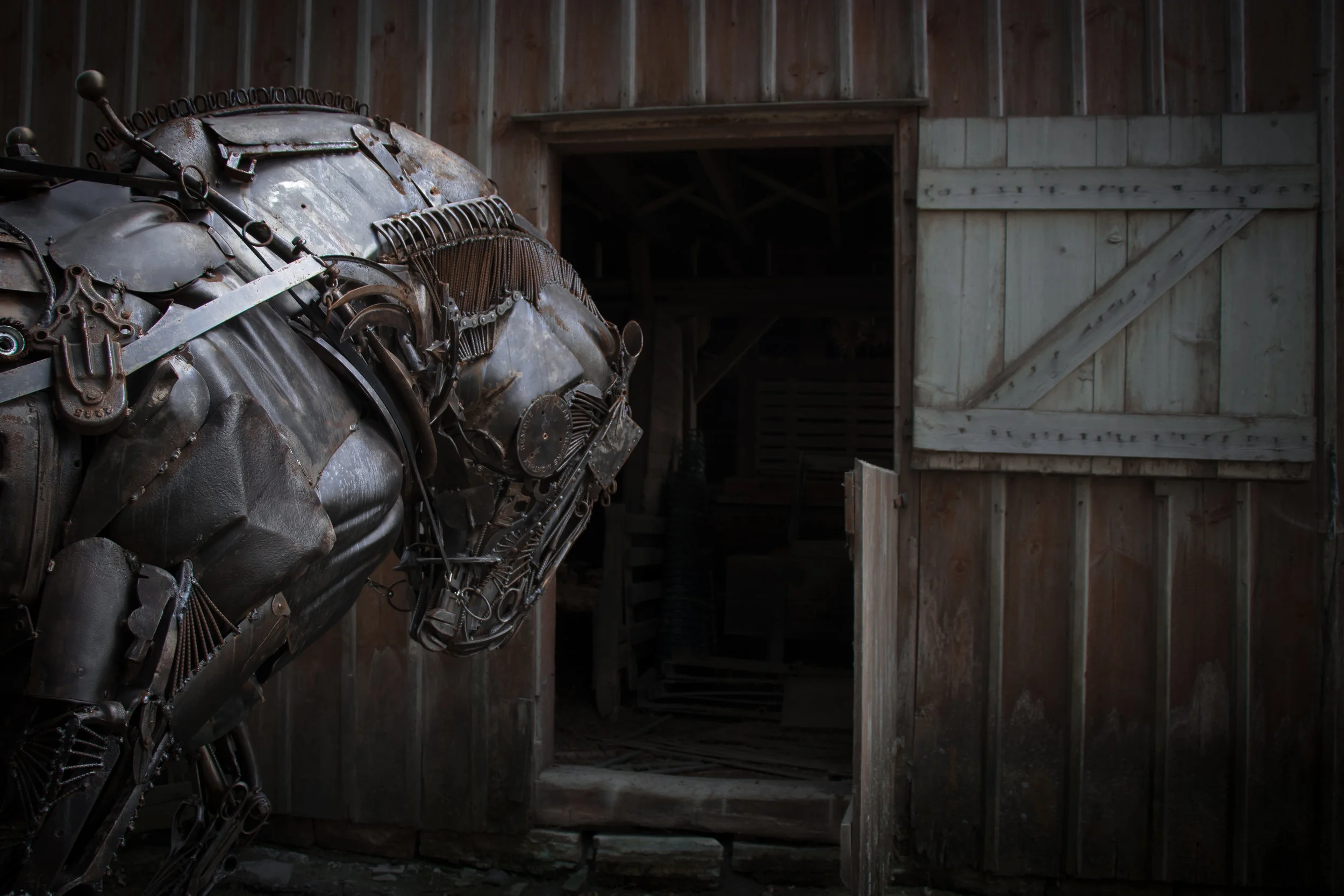 Draft horse sculpture heading into barn