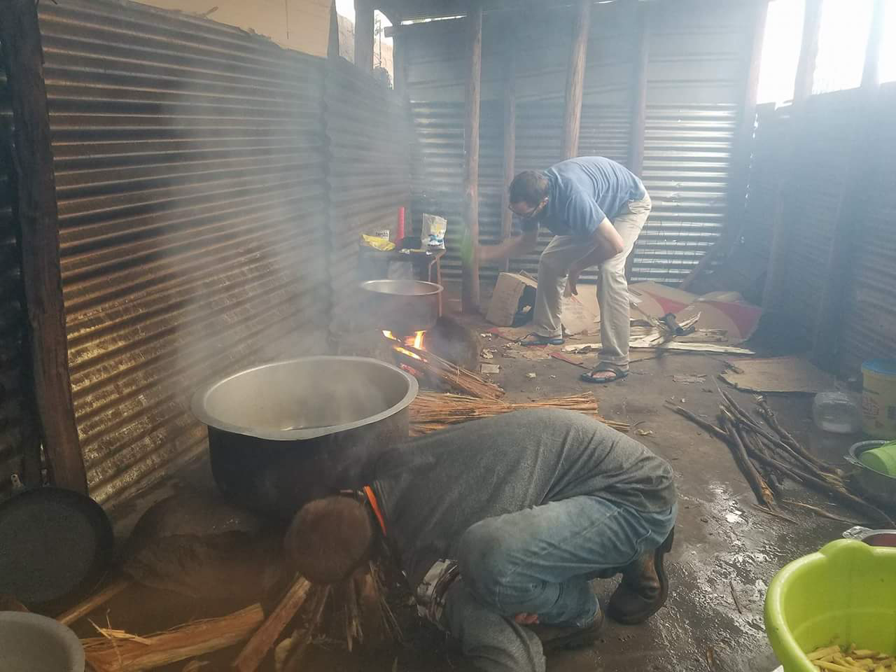 Karson and Jeff cooking chips (french fries) in our jikoni (Swahili for "kitchen")