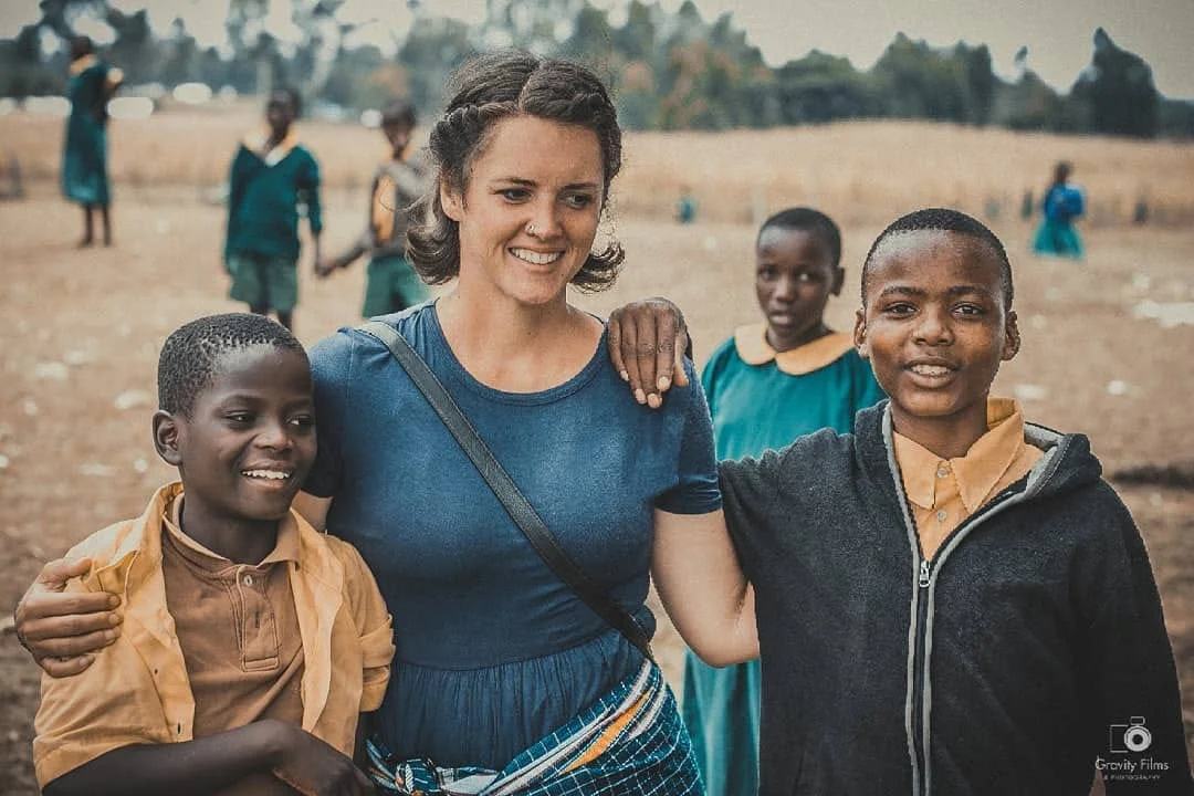 Stephanie with our kids during our lunch break time at their local school. We carry lunch to all our kids and feed them there. 