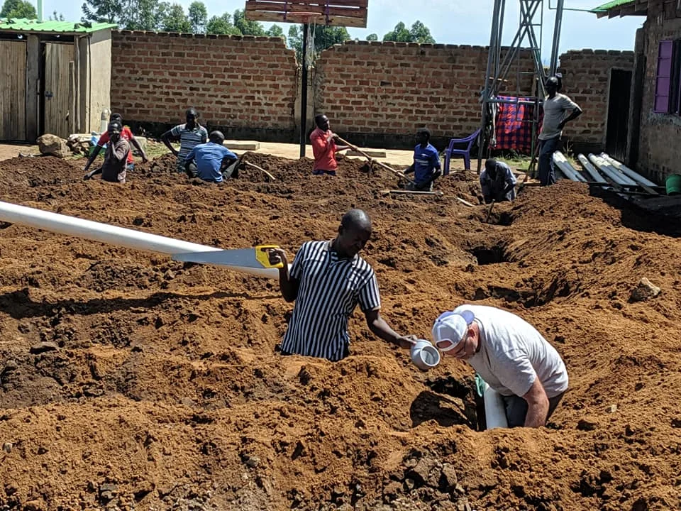 Conrad our construction manager with David working in the ditches to resolve our sewage problems