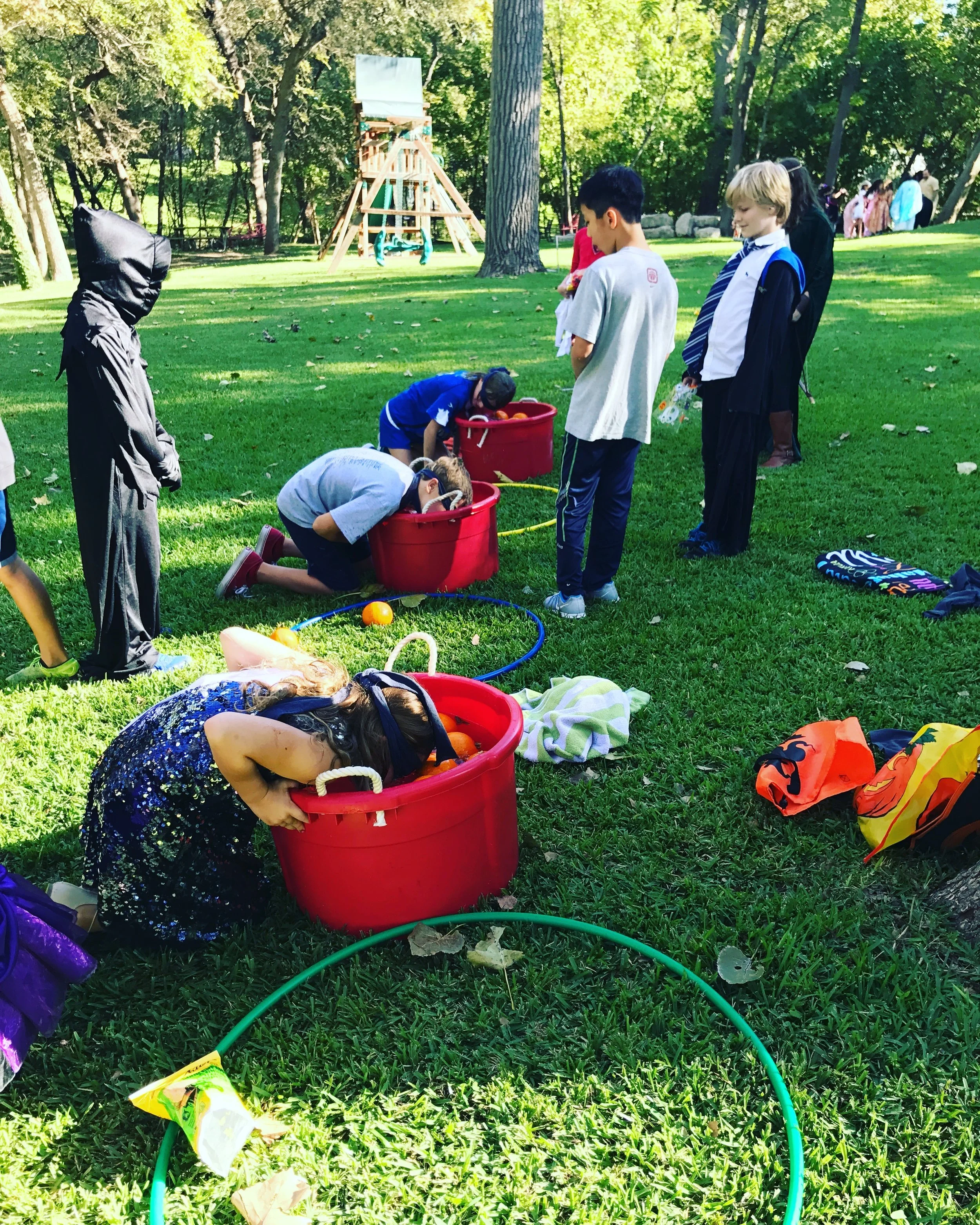 Bobbing for pumpkins at a Halloween inspired birthday party