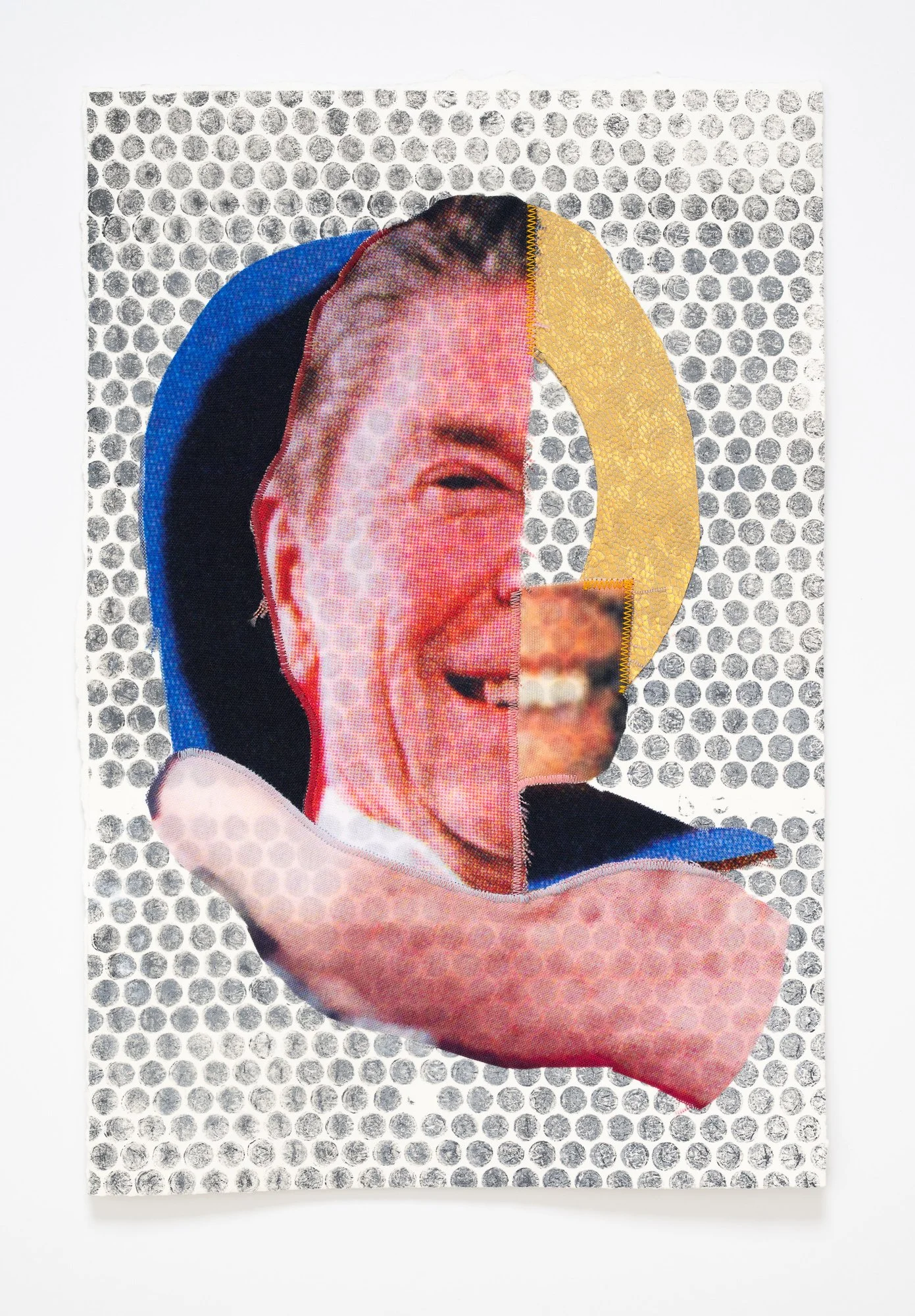 A fabric collage of Ronald Reagan mounted to dotted paper.