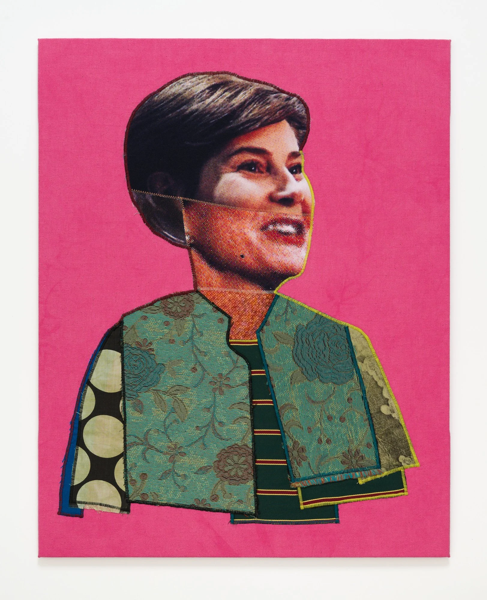 A stiffly upright First Lady wearing a green jacket and a steadfast smile.