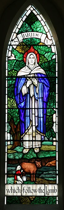 A stained-glass window featuring St Bride dominates the rear wall of St Bride's church.