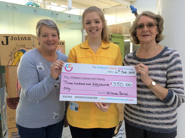Iris and Lillian present the cheque to Rebecca from the unit.