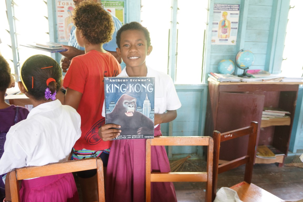 Student at Ravitaki Primary School with a new book.
