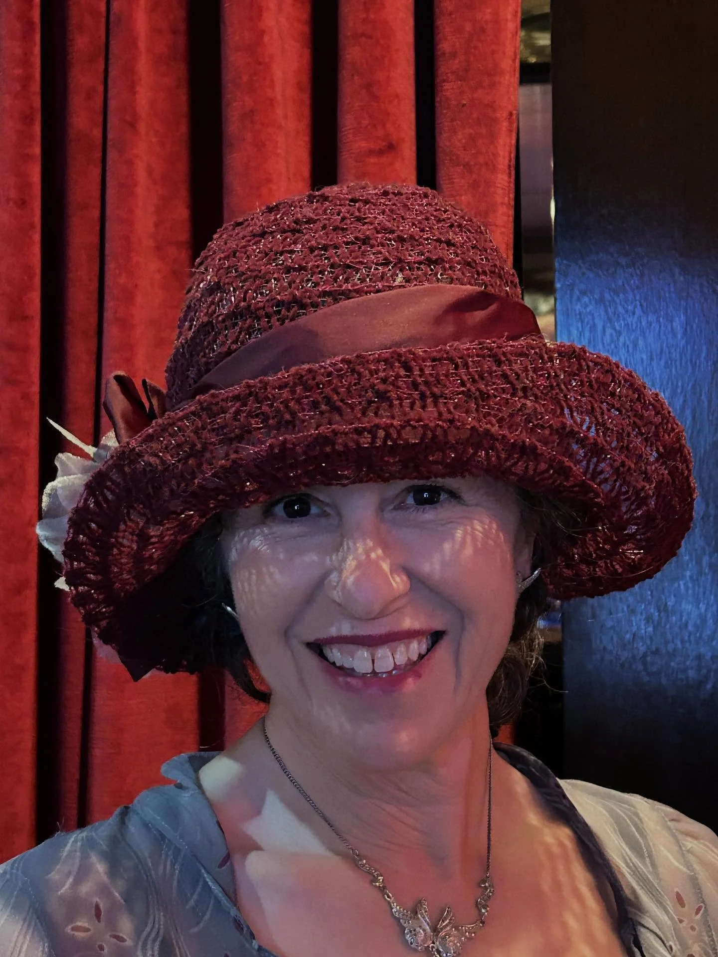 Love it when a client really loves her new hat. Hand sewn vintage braid created on a hat block I carved for another client and then added an upturn extension for Jennifer. Her dress was a 2920&rsquo;s style in gray with burgundy, so I added two hand 