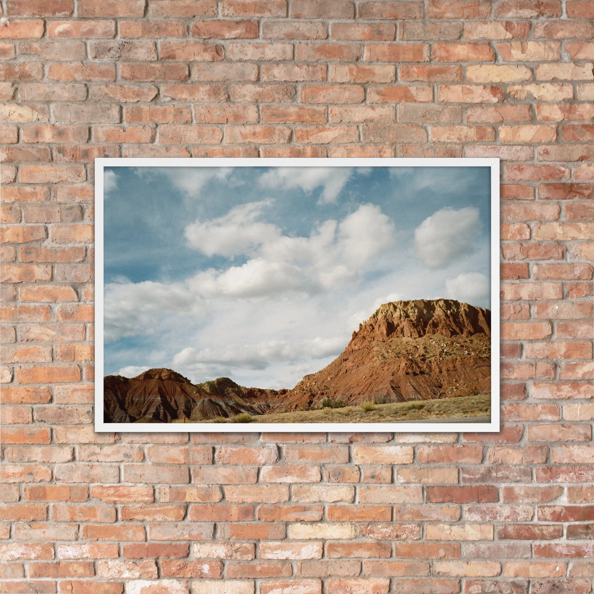 RED COUNTRY / 007 framed red mesas photograph by Nathon Ruehl on a brick wall