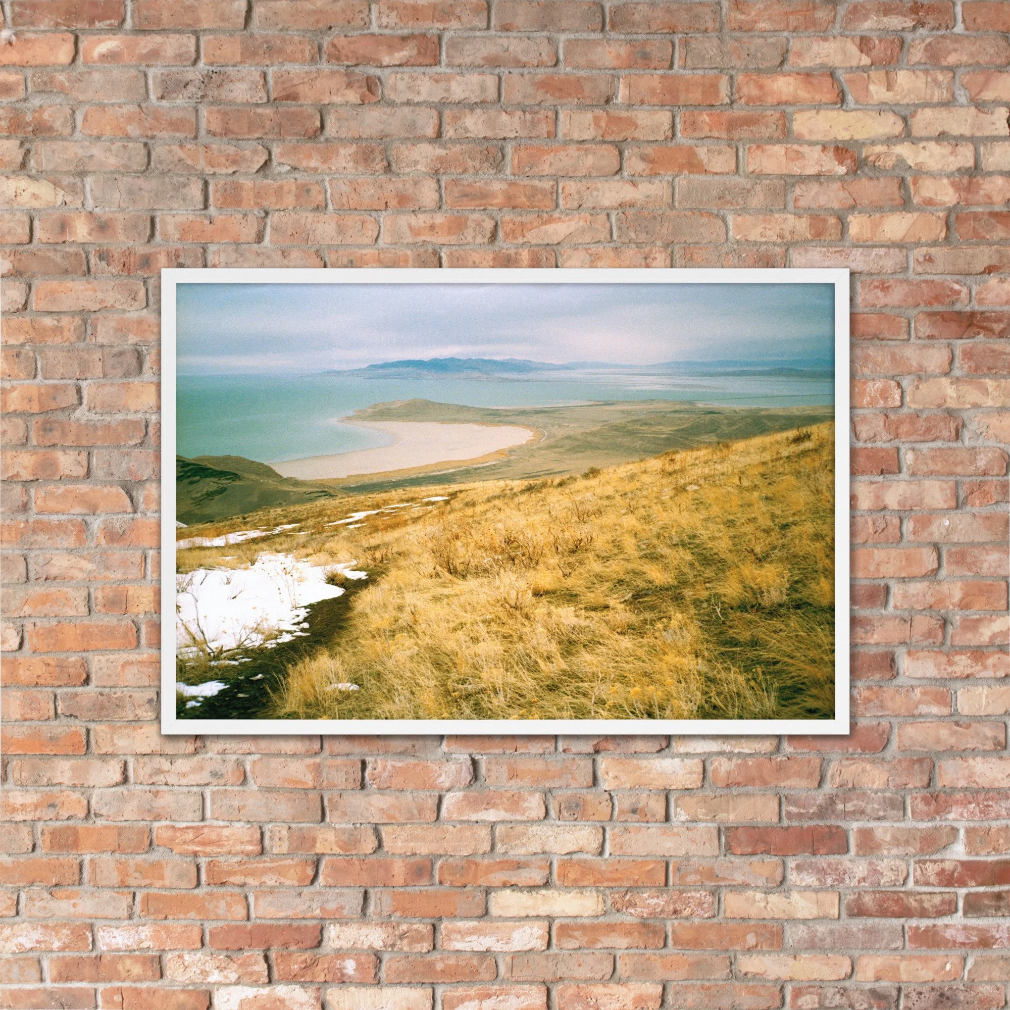 THAW / 002 framed winter high-plains photograph by Nathon Ruehl on a brick wall
