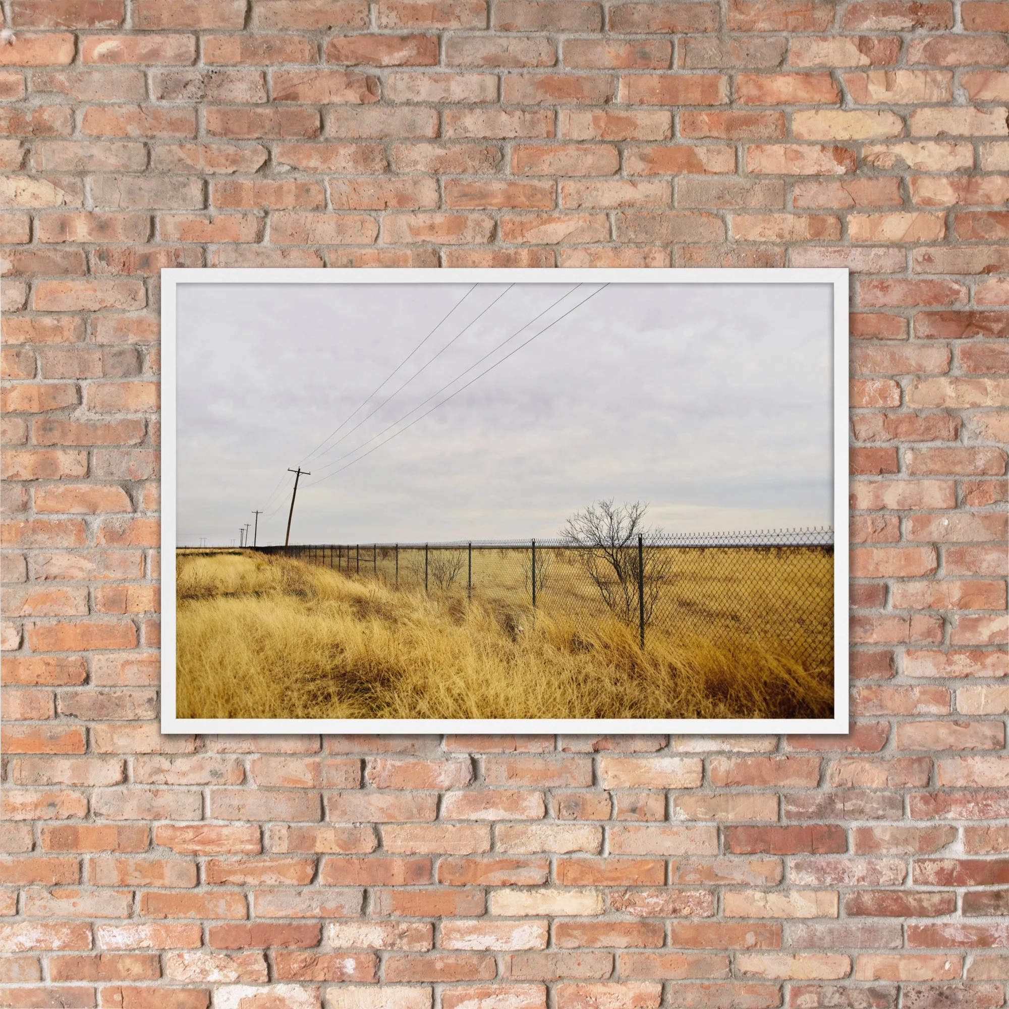 FENCE LINE / 003 framed fence and utility-pole photograph by Nathon Ruehl on a brick wall