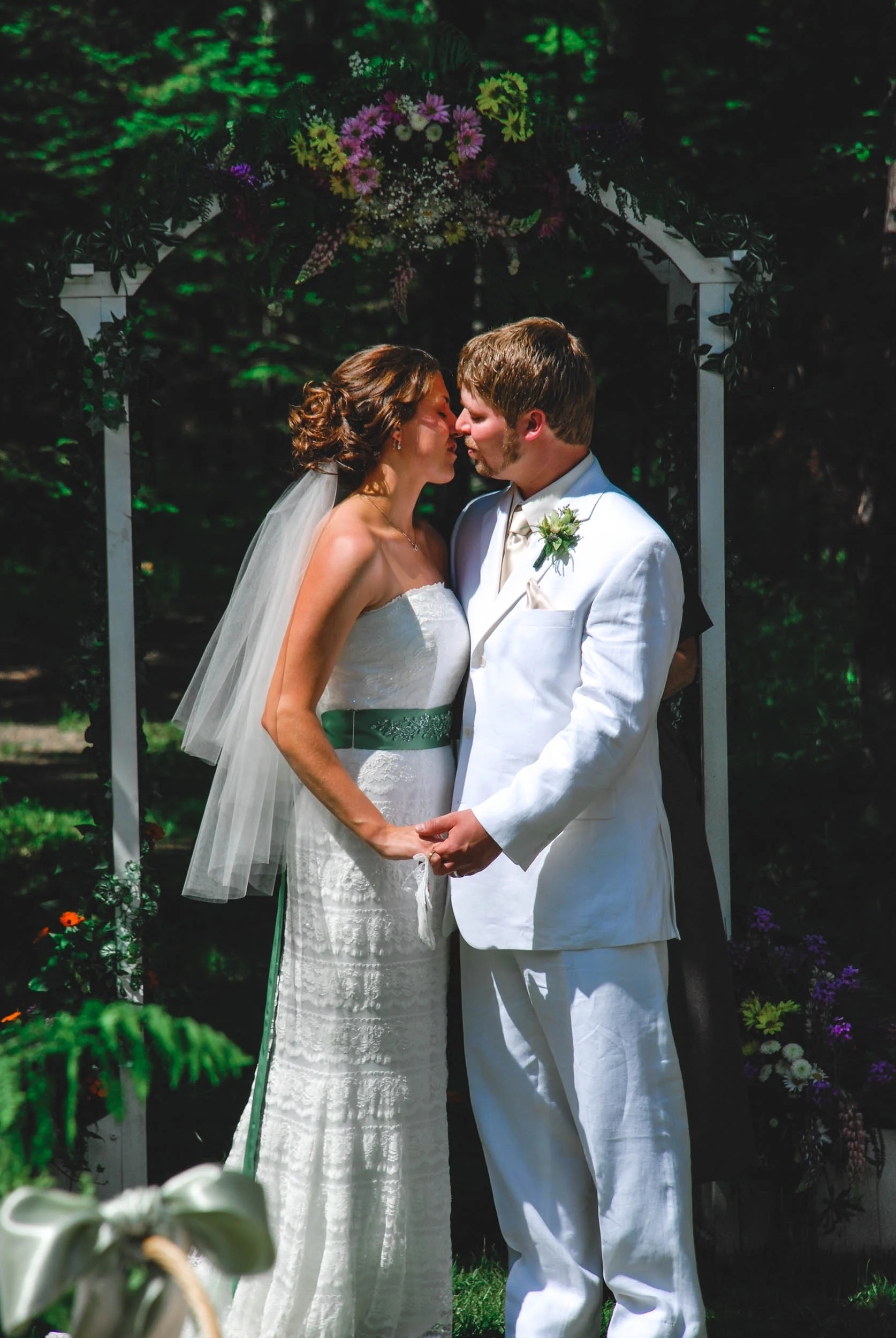First kiss as husband and wife outdoor summer WI wedding