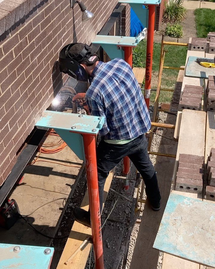 Supporting brick while installing new steel lintel over garage door.