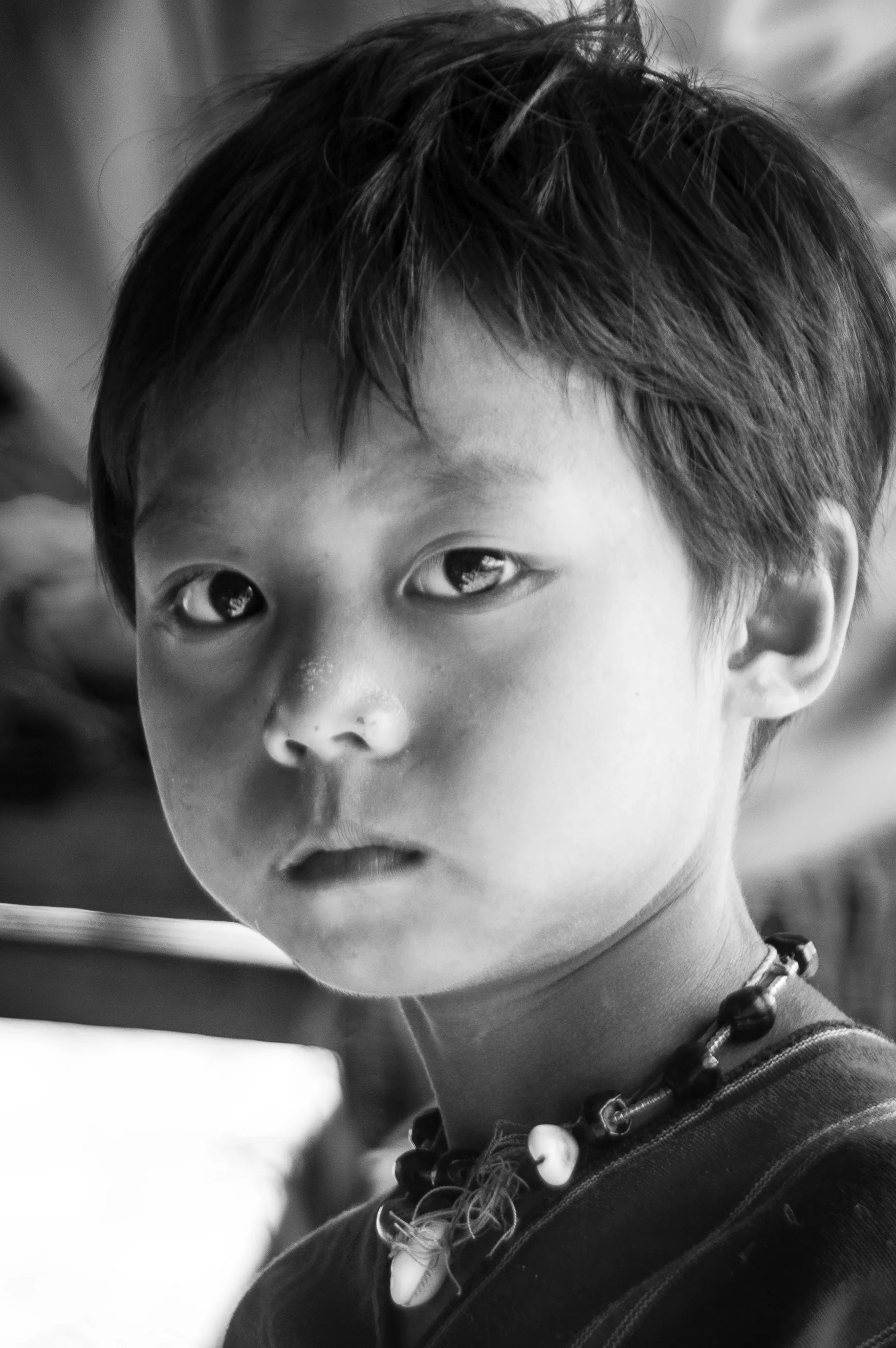 A village elder's grandchild. Northern Thailand. 