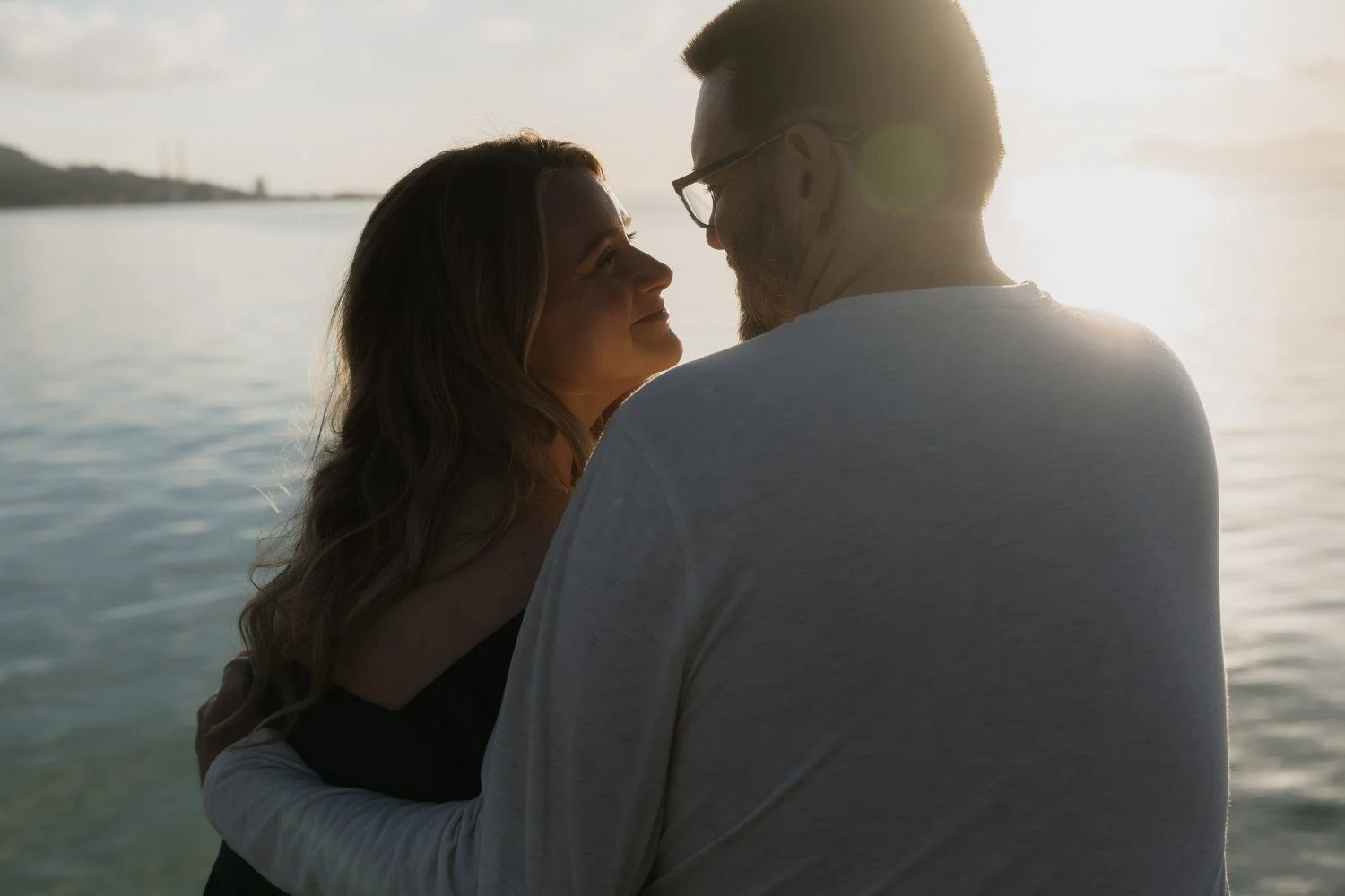 Romantic sunrise moment during an elopement in Mallorca, with a couple sharing an intimate look by the sea – captured by Mallorca wedding photographer Adrián Vilanova