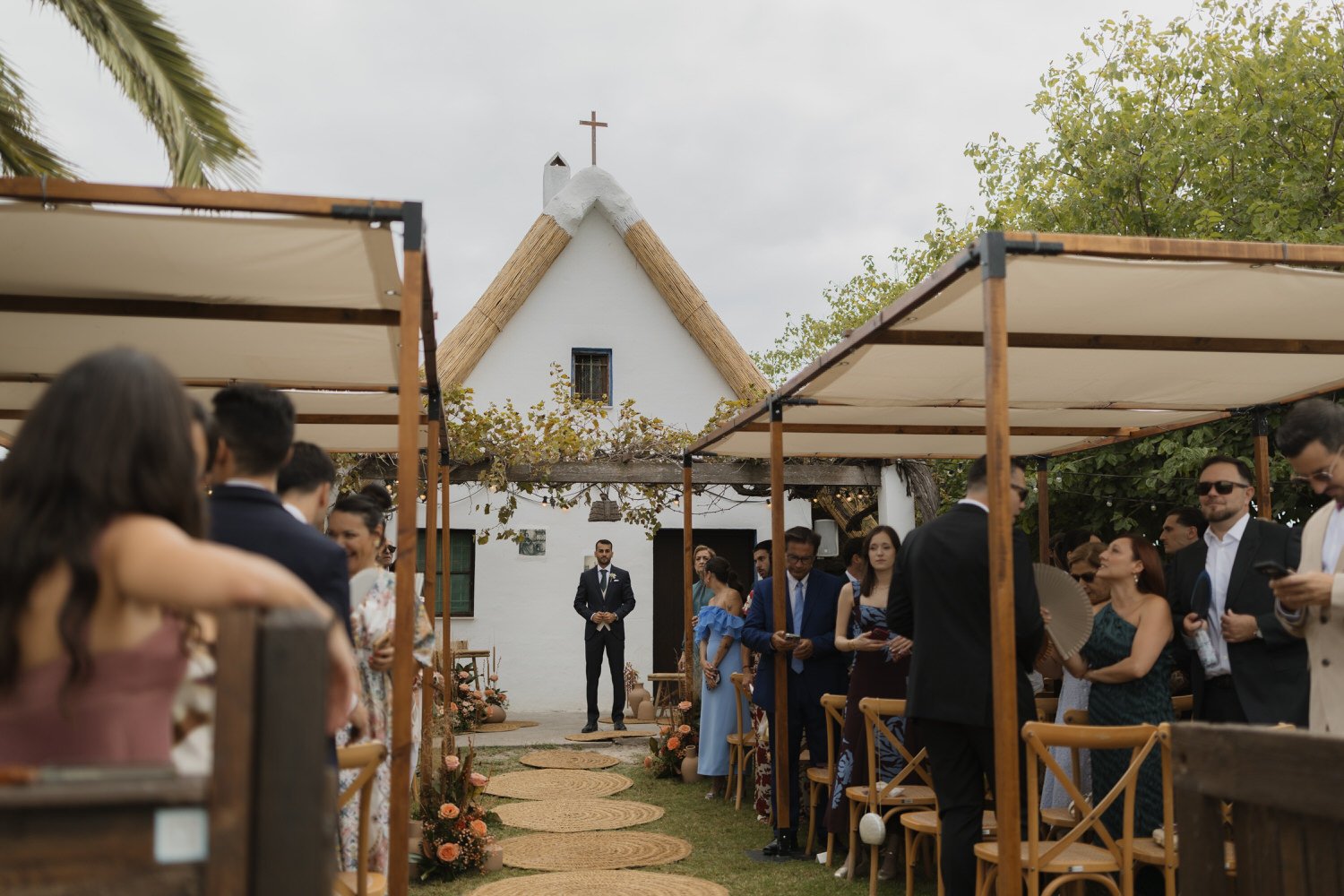 Groom waiting at the ceremony space as guests take their seats at La Barraca del Palmar