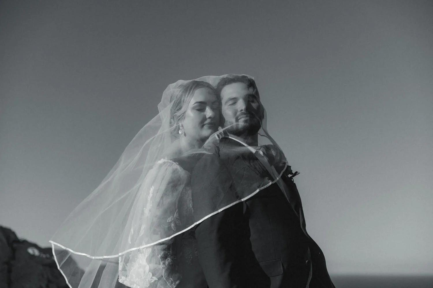 Artistic black and white portrait of a bride and groom beneath the veil during their Mallorca elopement.