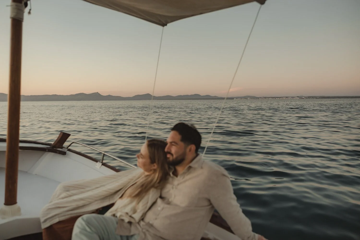 Couple enjoying a quiet sunrise boat ride on the Mediterranean Sea.