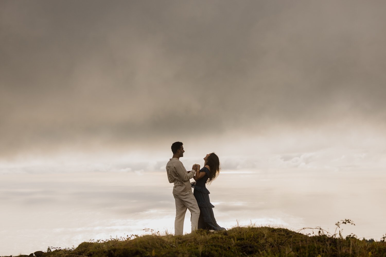 engaged couple celebrating on a hill at sunset in São Miguel Azores