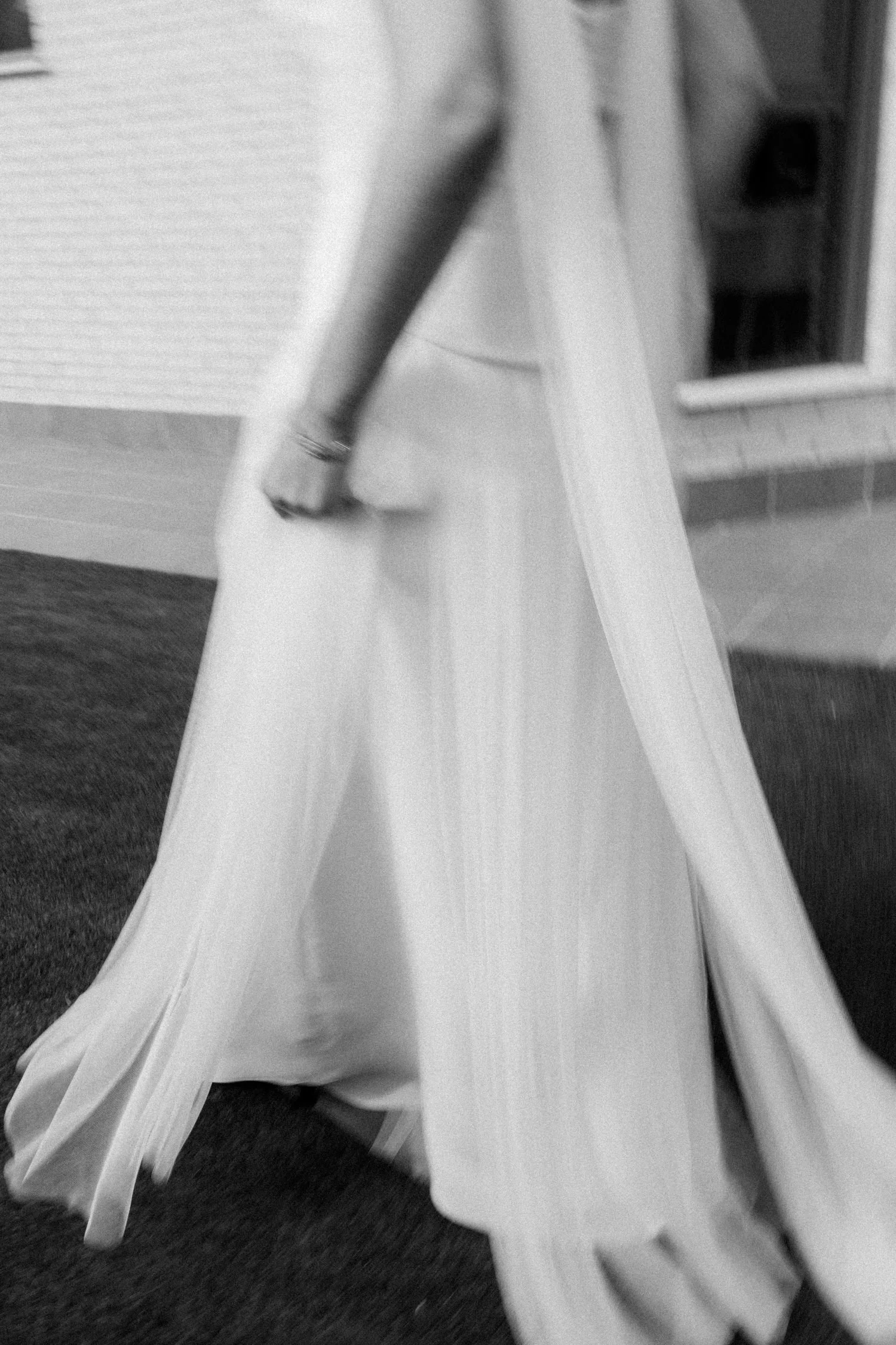 Abstract detail of the bride’s dress and veil in motion during wedding preparations