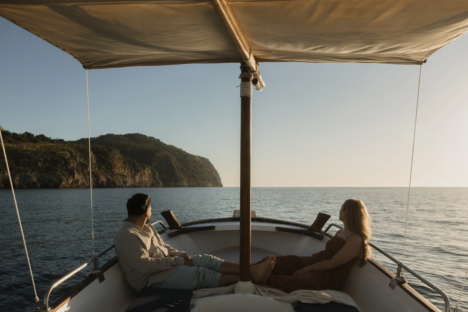 Couple enjoying a quiet sunrise boat trip along the Mallorca coastline before their elopement.
