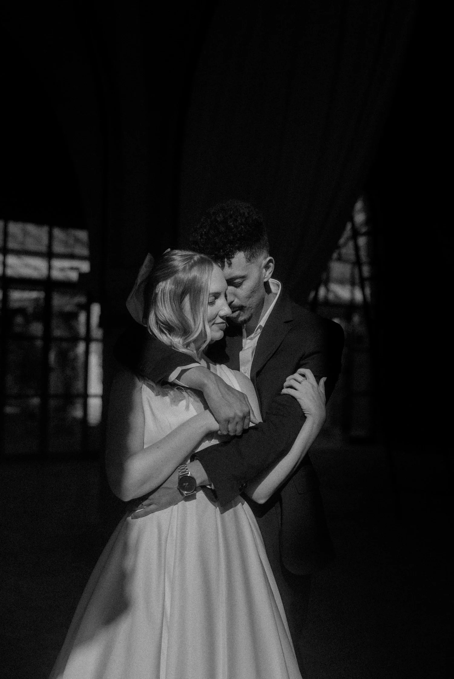 Bride and groom embracing in soft dramatic light inside Beldi Country Club during their Marrakech destination wedding.