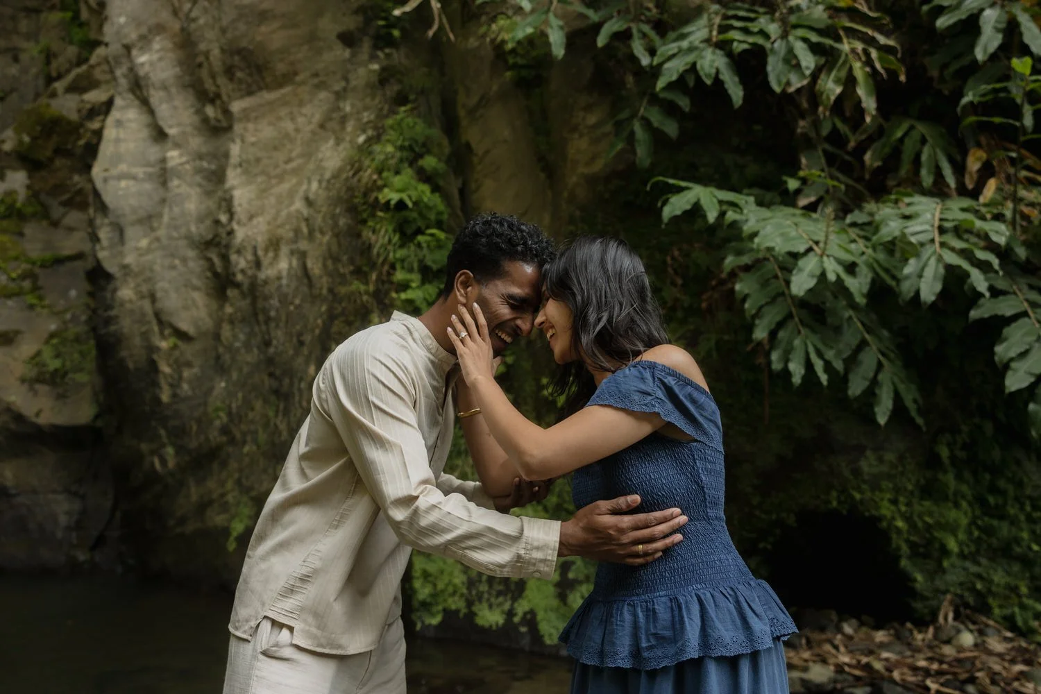 Romantic couple laughing together by hidden waterfall in São Miguel Azores