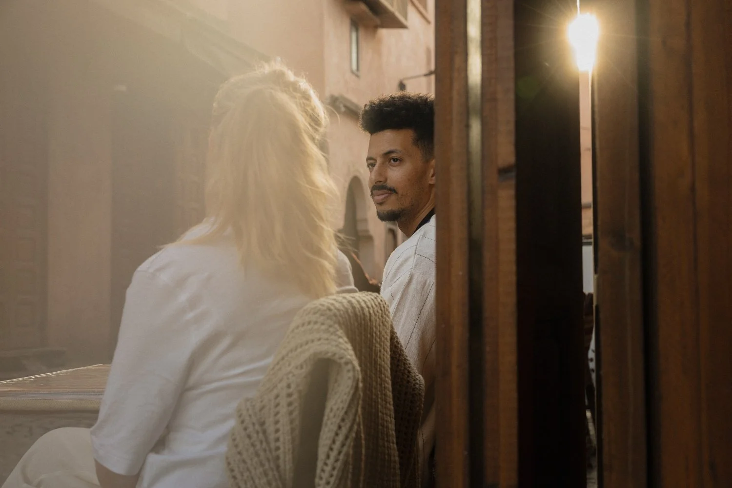 Candid moment of Katie and Amine sharing tea at sunset in Marrakech during their destination wedding weekend.