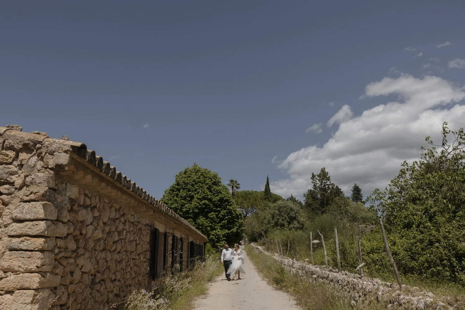 Bride and groom walking through the countryside after their Mallorca elopement ceremony