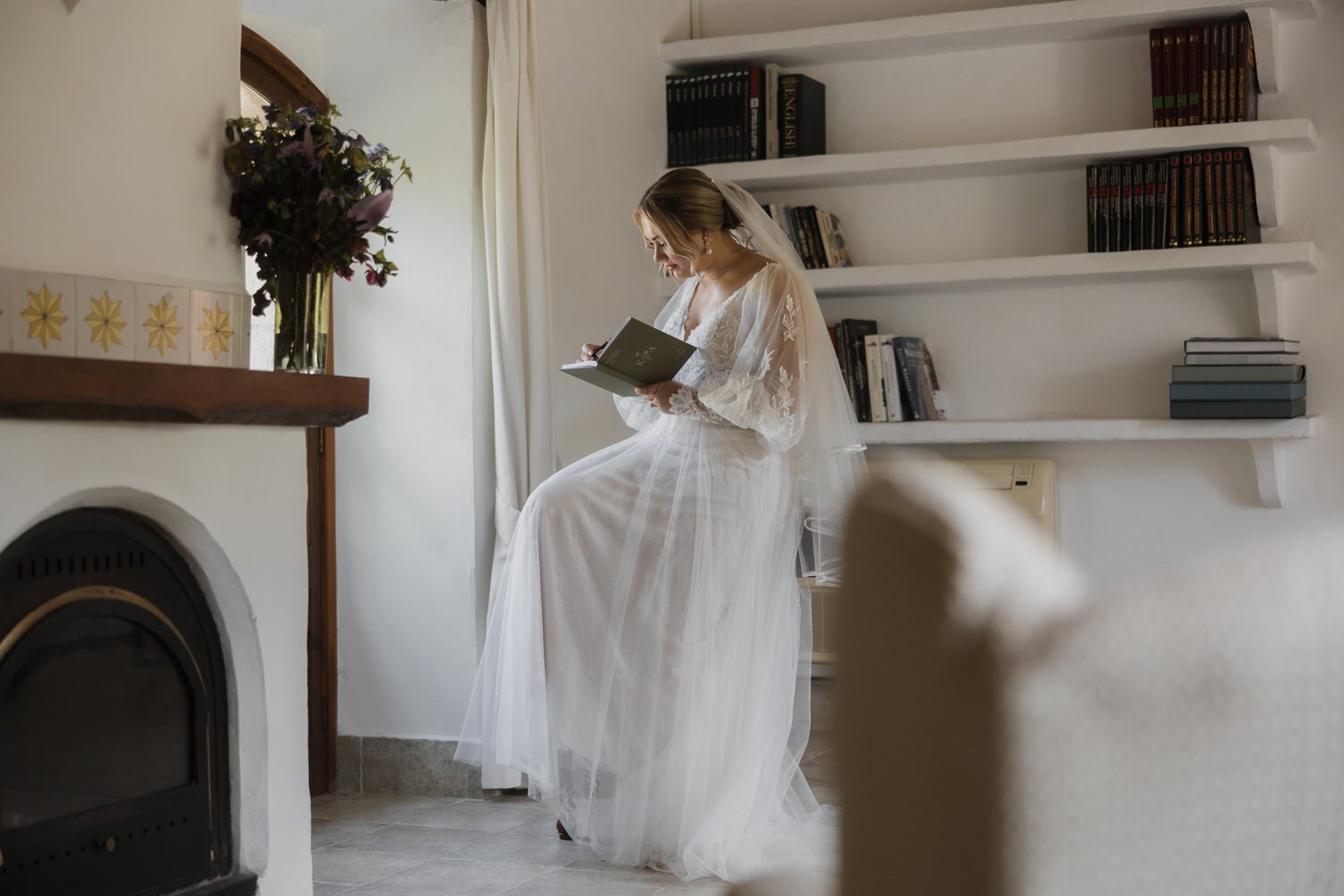 Bride writing her wedding vows by the window at a Mallorca finca