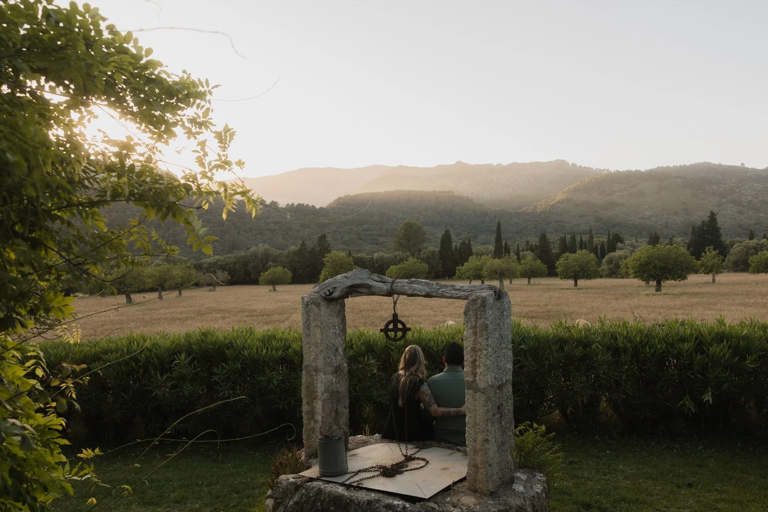 Couple watching the sunset over the Tramuntana mountains from a traditional Mallorcan finca.