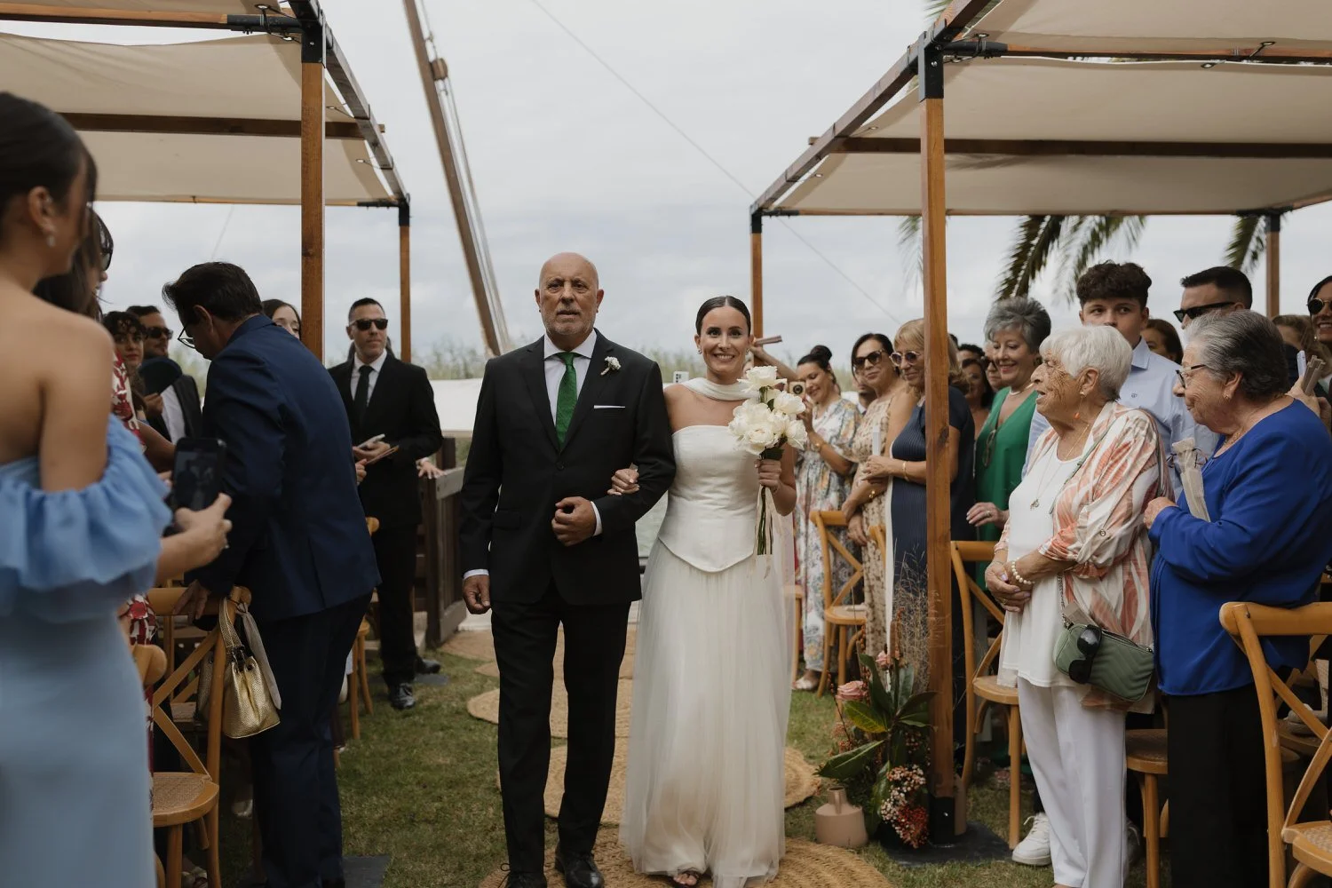 Bride walking down the aisle with her father during the ceremony at La Barraca del Palmar