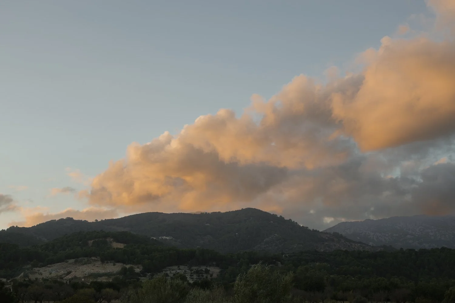 Golden sunset clouds over the Tramuntana mountains during an elopement day in Mallorca