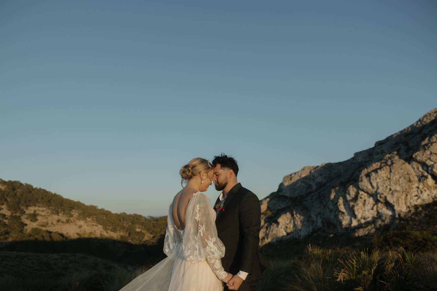 Bride and groom sharing a quiet moment after exchanging vows during their sunset elopement in Mallorca.