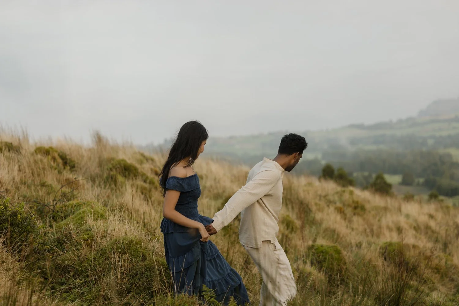 couple walking through the hills of São Miguel Azores after their engagement