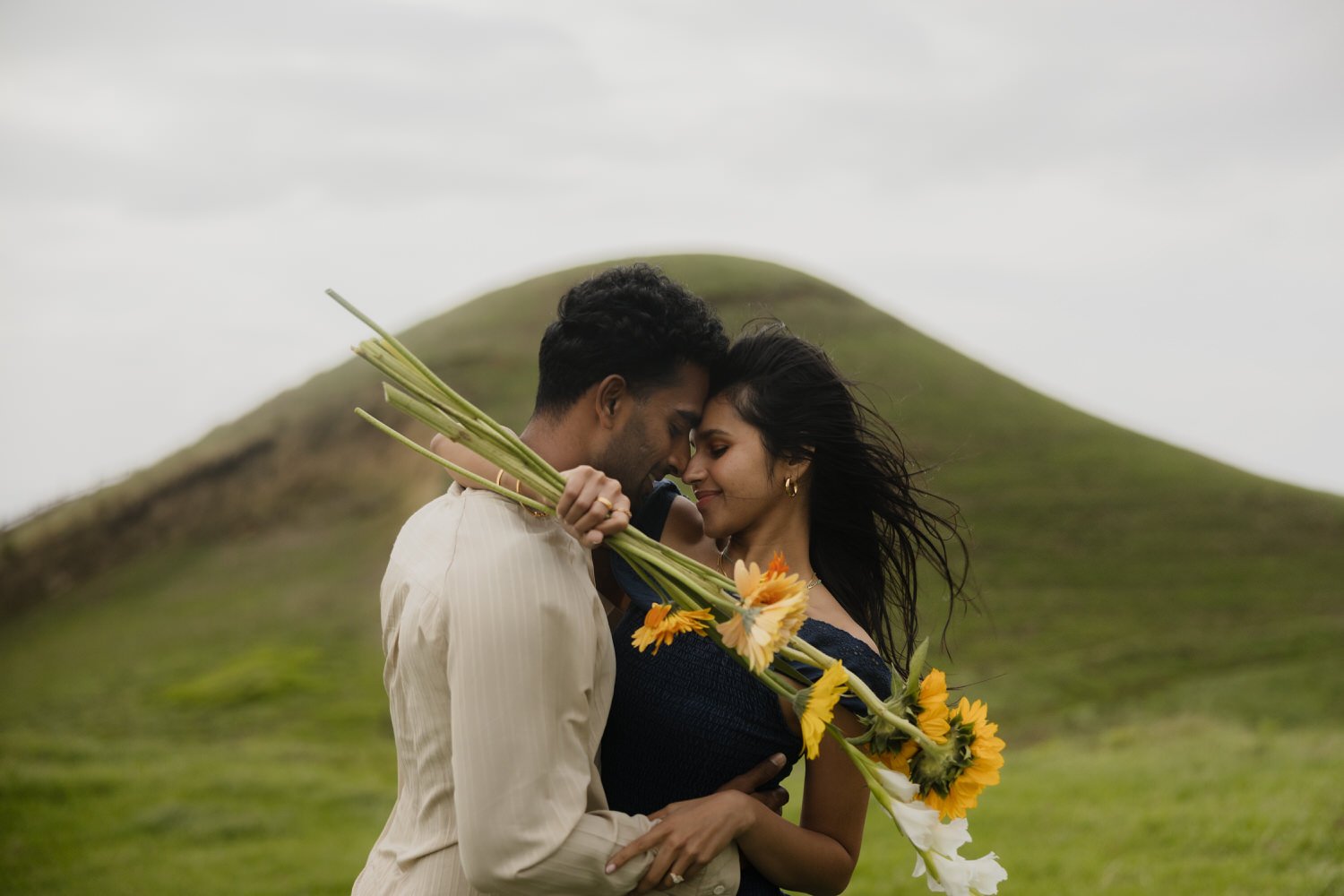 couple embracing with flowers after engagement in São Miguel Azores