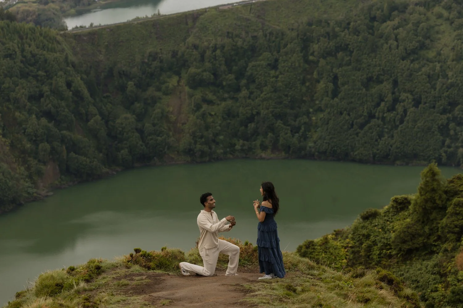 man proposing on a cliff overlooking Sete Cidades lake São Miguel Azores
