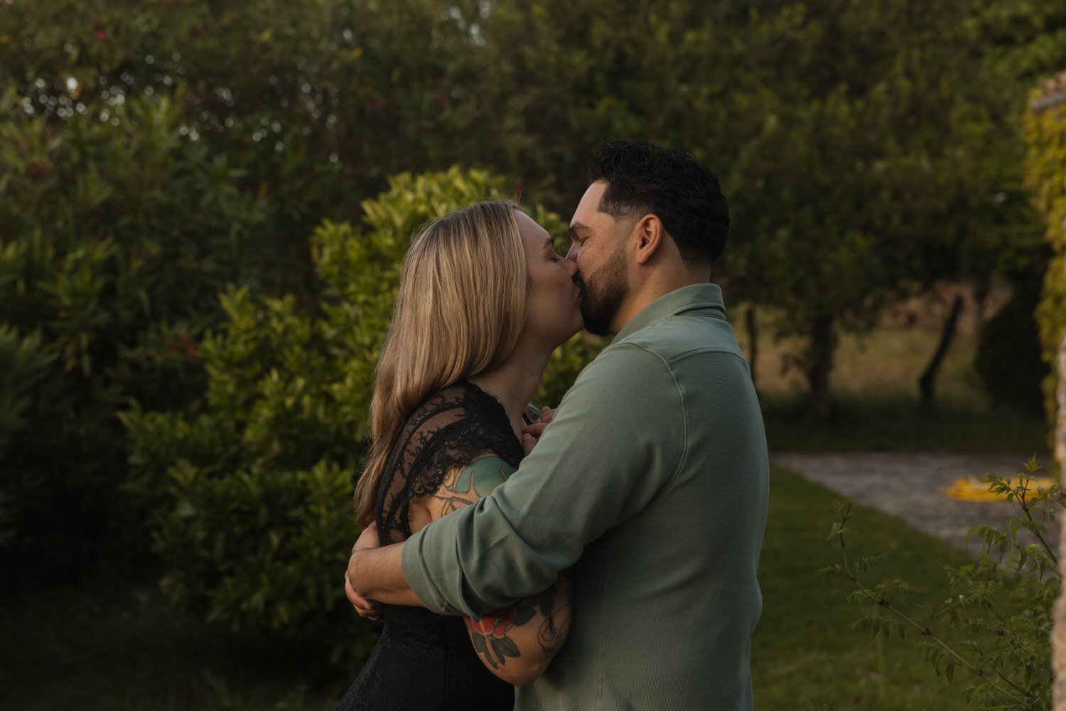 Couple sharing a kiss during a relaxed evening at their Mallorcan finca.