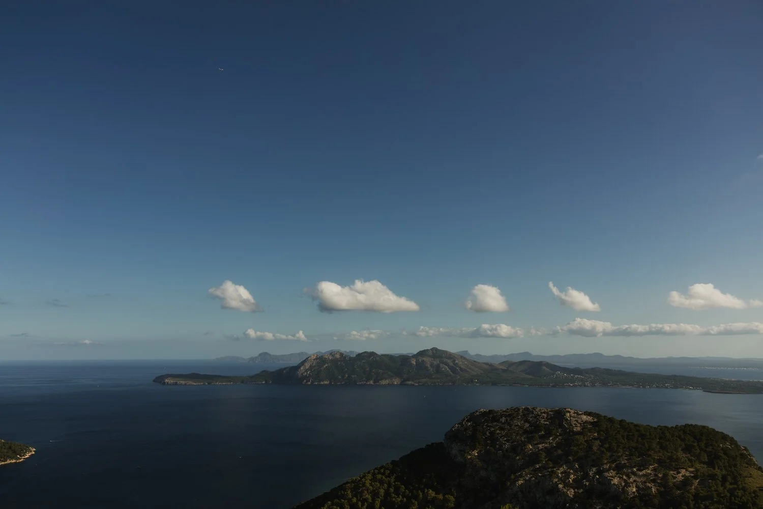 Scenic landscape of Cap de Formentor coastline in northern Mallorca with deep blue sea, clouds and Serra de Tramuntana mountains – Mallorca elopement location