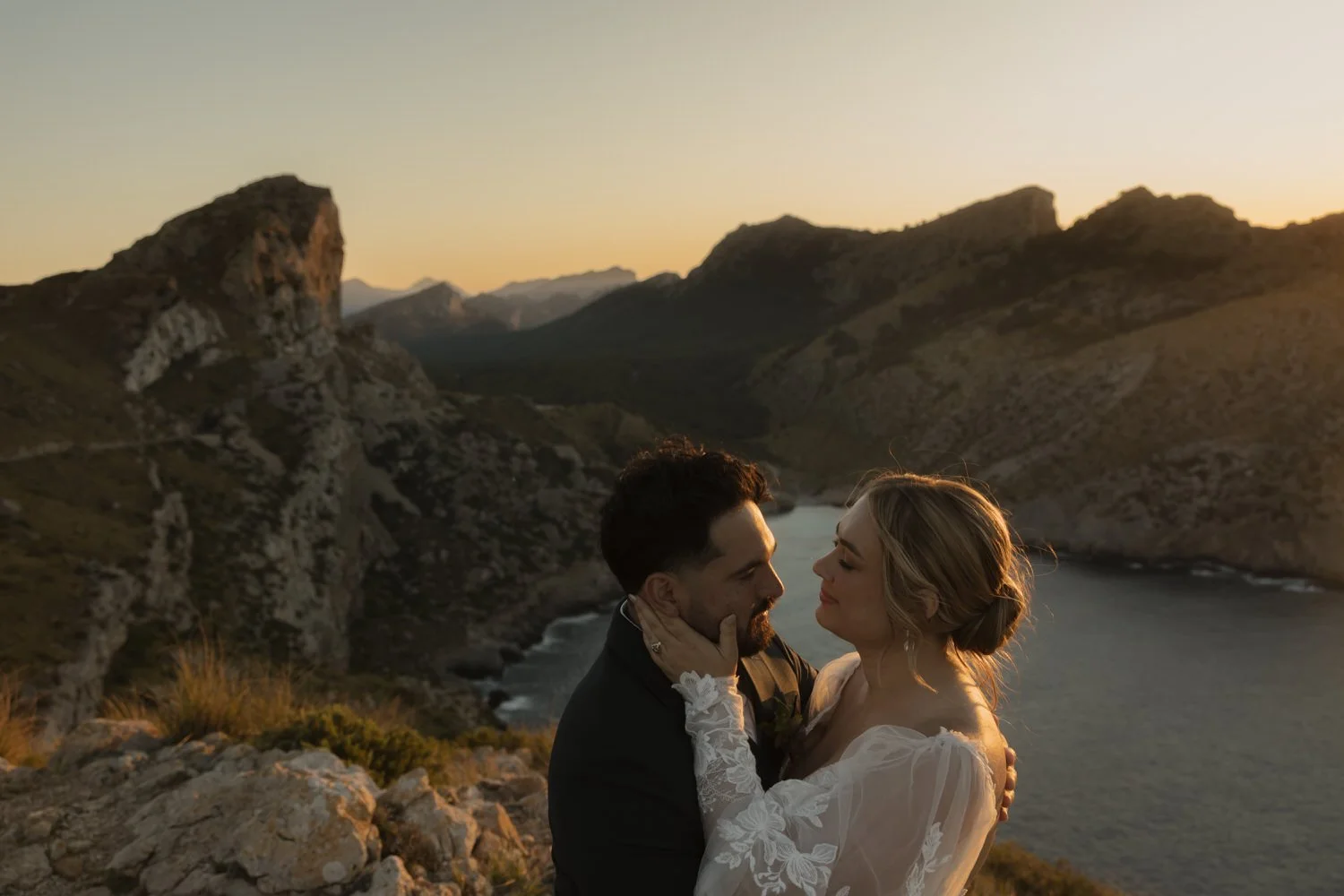Bride and groom sharing their first kiss after a cliffside elopement ceremony in Mallorca.