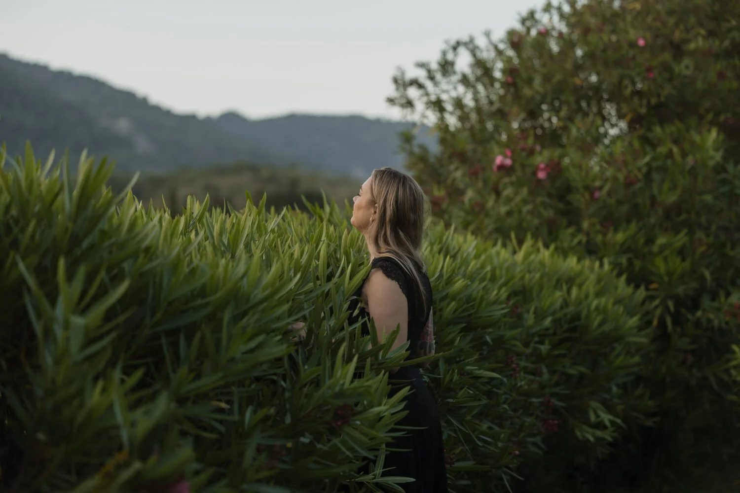 Quiet portrait surrounded by lush Mediterranean gardens.