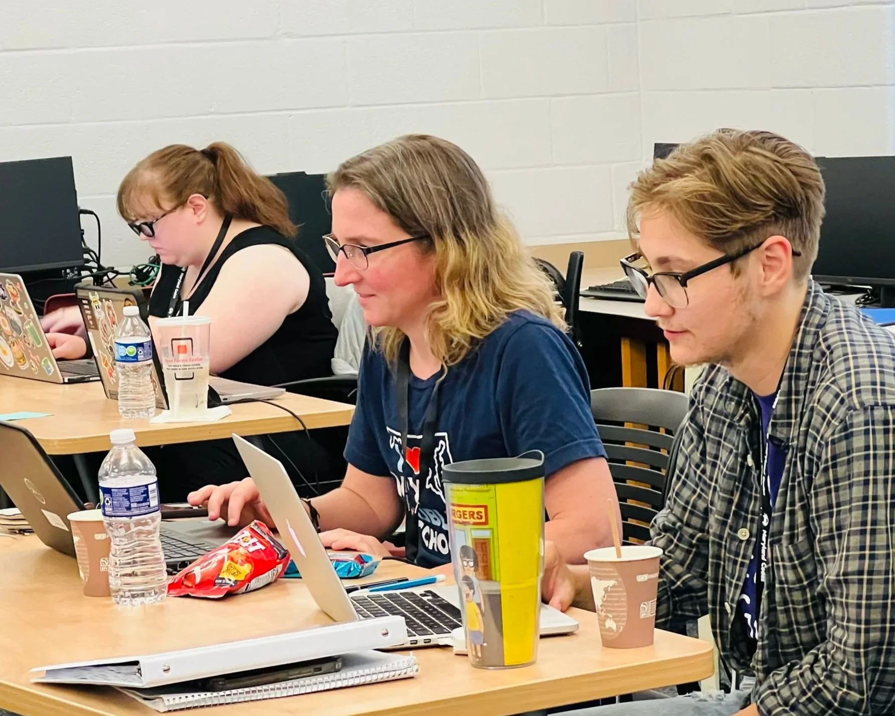 teachers with laptops in a classroom
